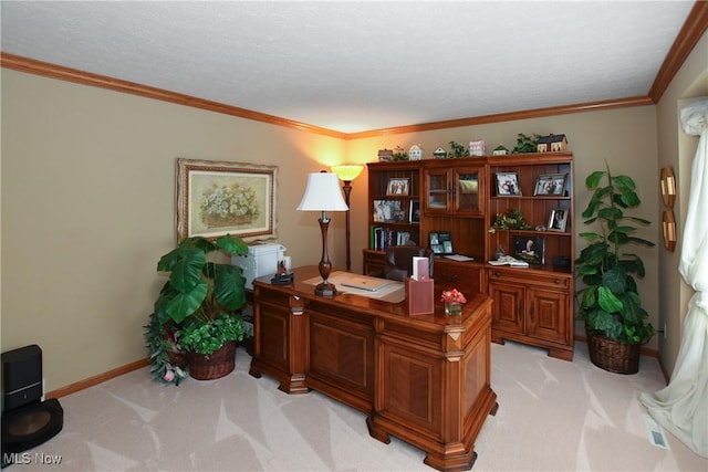 office area with baseboards, crown molding, and light colored carpet