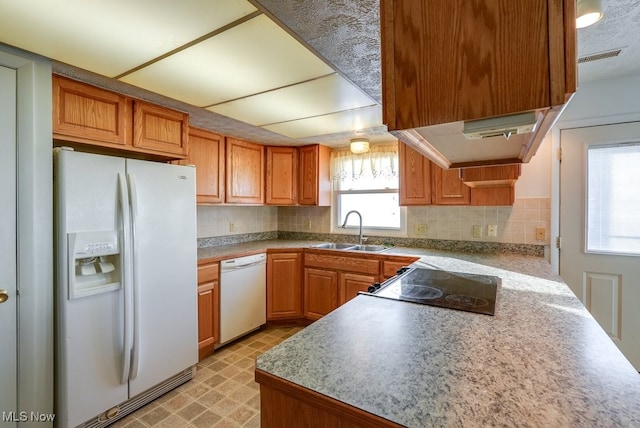 kitchen featuring ventilation hood, backsplash, sink, and white appliances