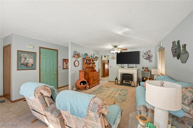 living room with ceiling fan and a textured ceiling