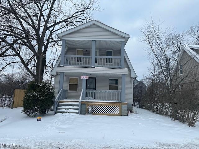 view of front of property with covered porch and a balcony