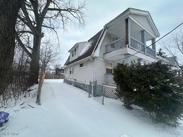 view of snowy exterior with a balcony