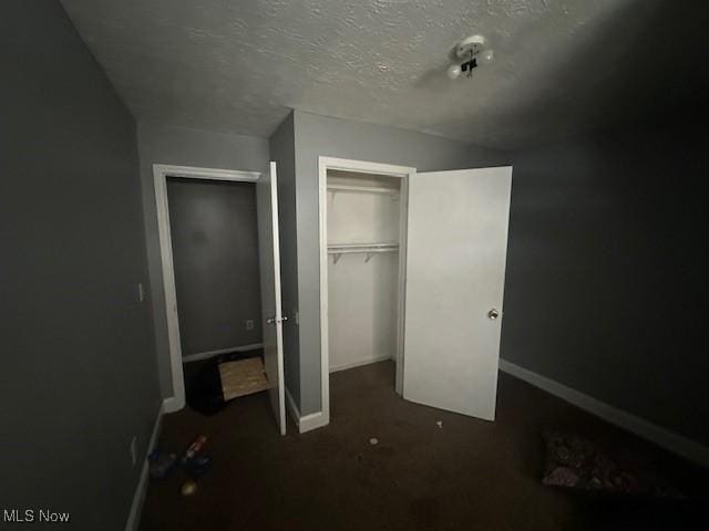 bedroom with a textured ceiling and a closet