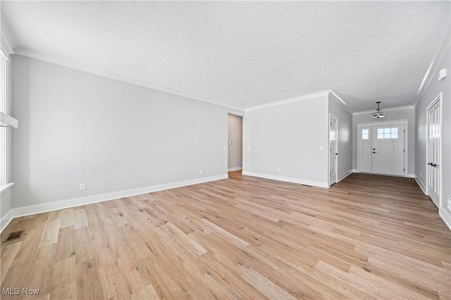 unfurnished living room with light wood-type flooring and crown molding