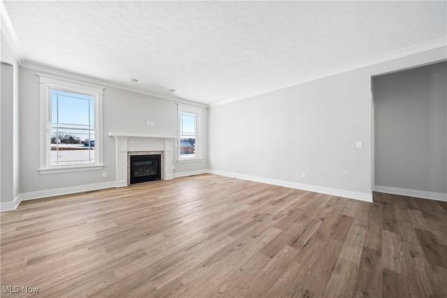 unfurnished living room featuring light wood-type flooring and a textured ceiling