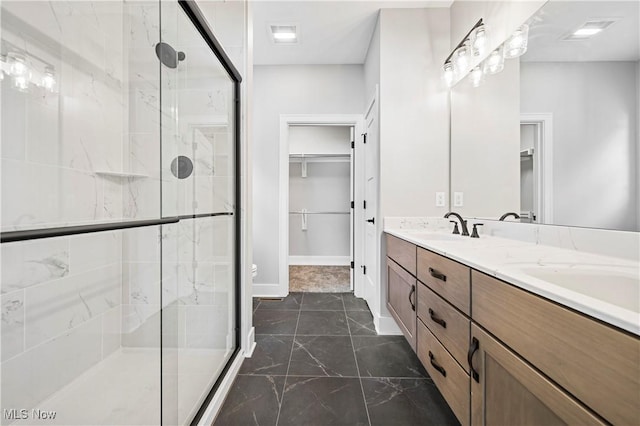 bathroom featuring an enclosed shower and vanity