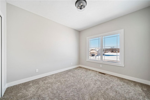 spare room featuring carpet floors