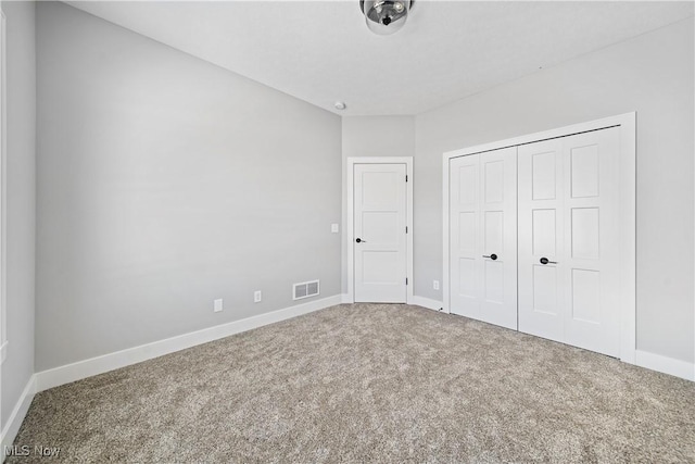 unfurnished bedroom with carpet floors and a closet