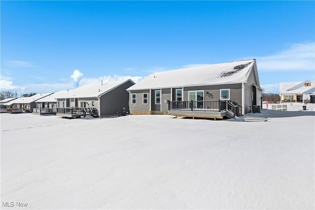 snow covered property featuring a wooden deck