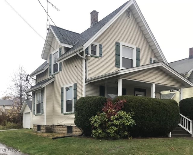 view of side of home with a garage and a lawn