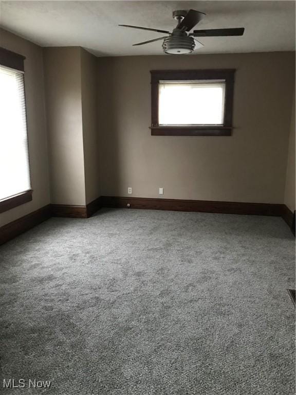 empty room featuring ceiling fan and carpet flooring