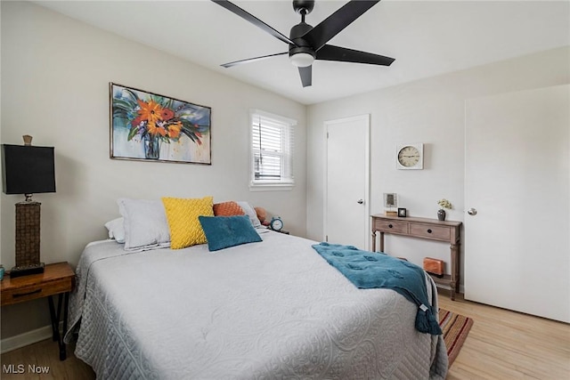 bedroom with light hardwood / wood-style flooring and ceiling fan