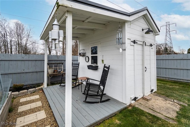 wooden deck featuring an outbuilding