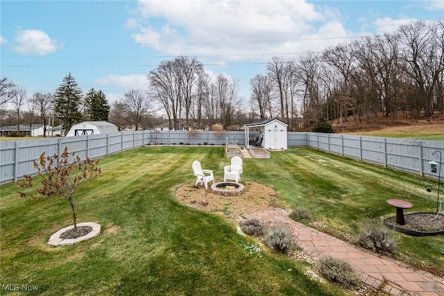 view of yard featuring a fire pit and a shed