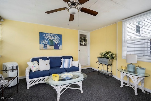 living room with ceiling fan and dark colored carpet