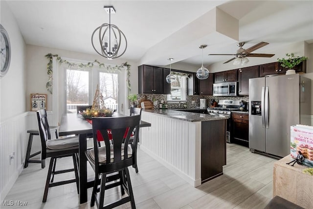 kitchen featuring decorative backsplash, hanging light fixtures, appliances with stainless steel finishes, and dark brown cabinets