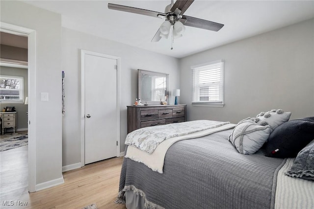 bedroom with ceiling fan and light wood-type flooring