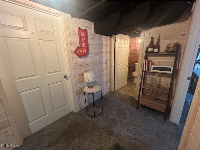 hallway with dark colored carpet