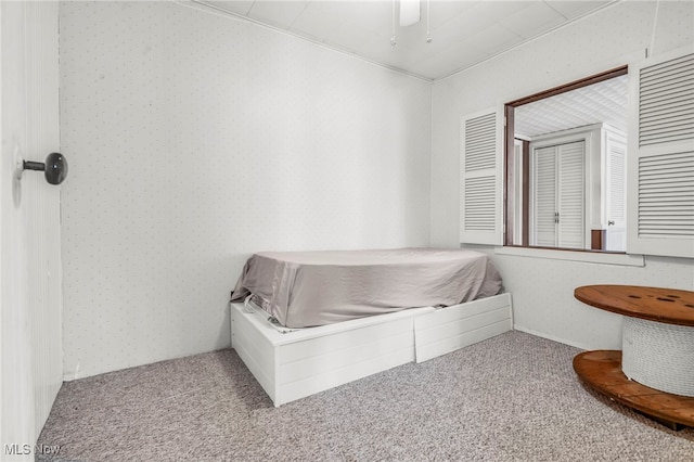 bedroom featuring wallpapered walls, carpet flooring, and ceiling fan