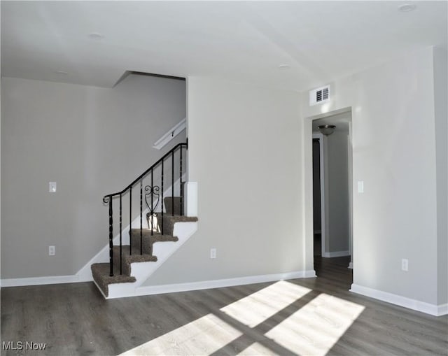 stairs featuring hardwood / wood-style floors