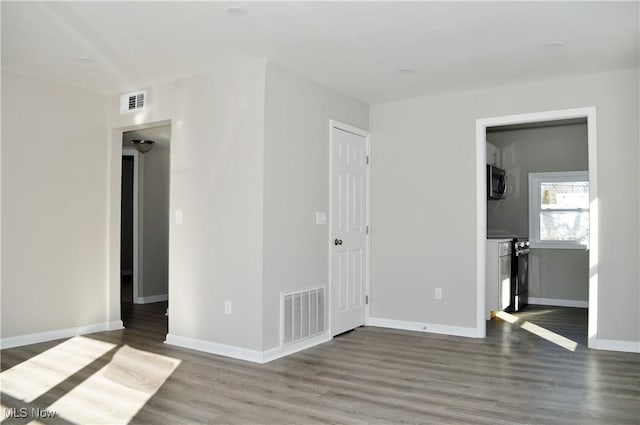 spare room with wood-type flooring