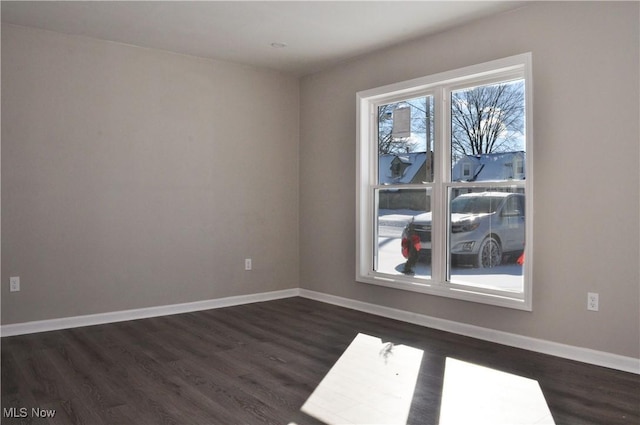 spare room with dark hardwood / wood-style floors