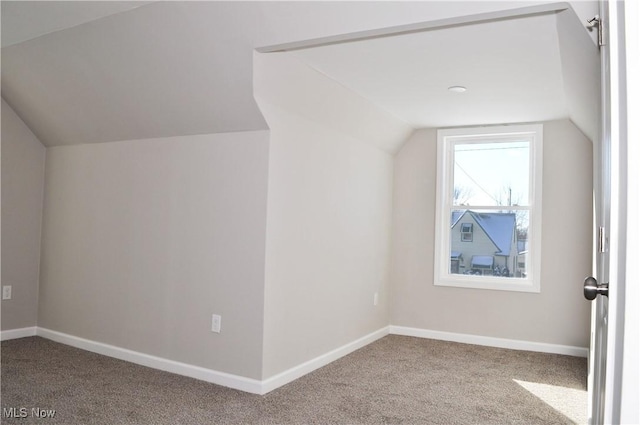 bonus room with carpet and vaulted ceiling