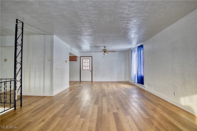 spare room featuring ceiling fan and light wood-type flooring