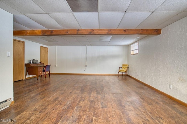 basement with dark wood-type flooring and a baseboard radiator