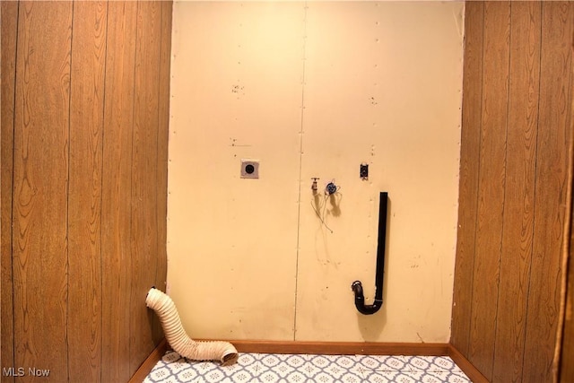 washroom with wood walls and electric dryer hookup