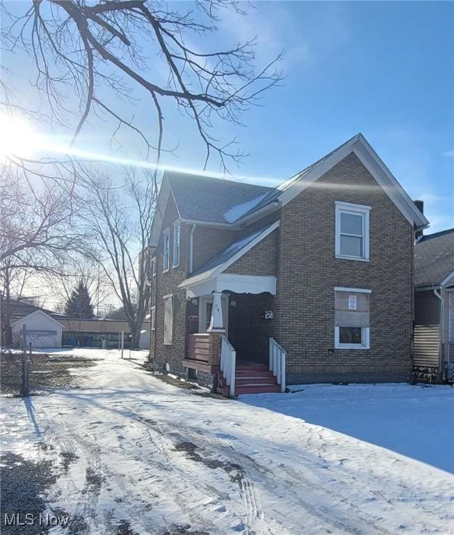 view of snowy exterior with a garage