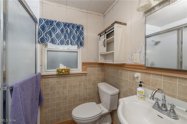 bathroom featuring sink, tile walls, toilet, and walk in shower