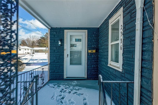 view of snow covered property entrance