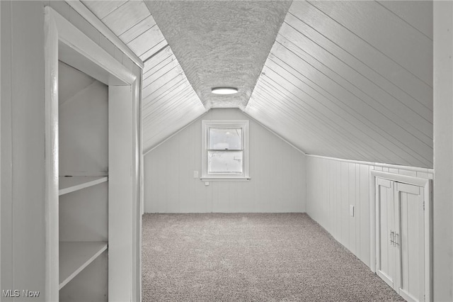 bonus room with carpet and lofted ceiling