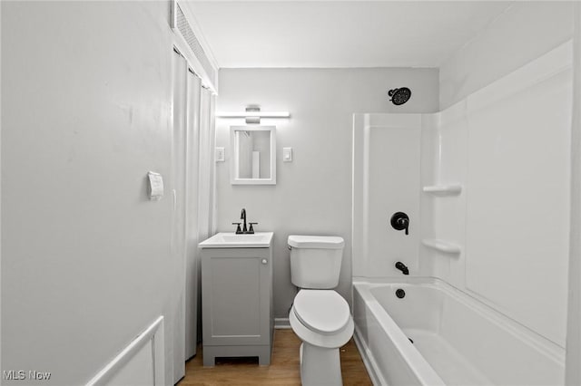 full bathroom with hardwood / wood-style flooring, shower / tub combination, vanity, and toilet