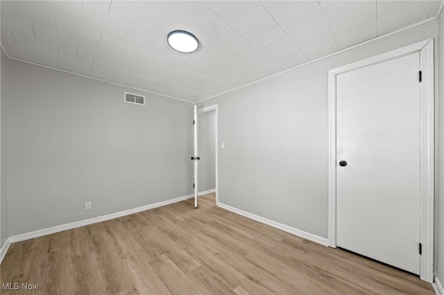 unfurnished room with light wood-type flooring