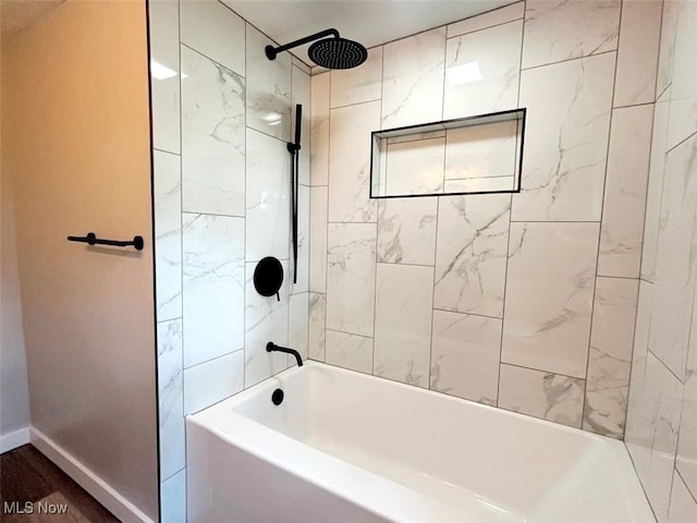 bathroom featuring hardwood / wood-style flooring and tiled shower / bath combo