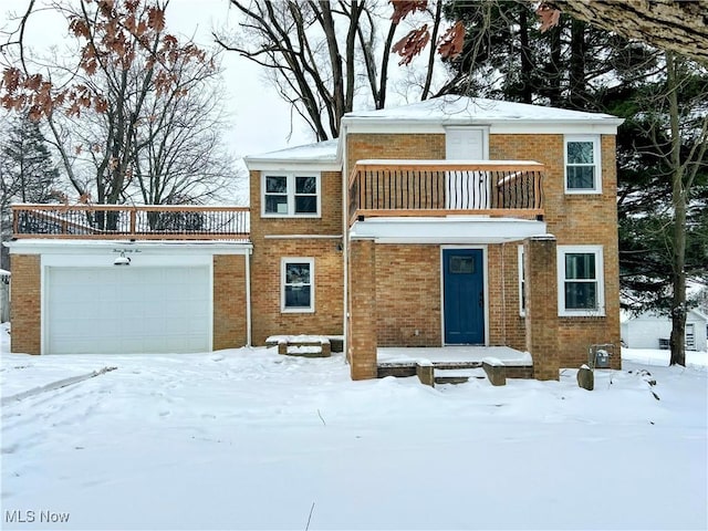 view of front facade featuring a balcony and a garage