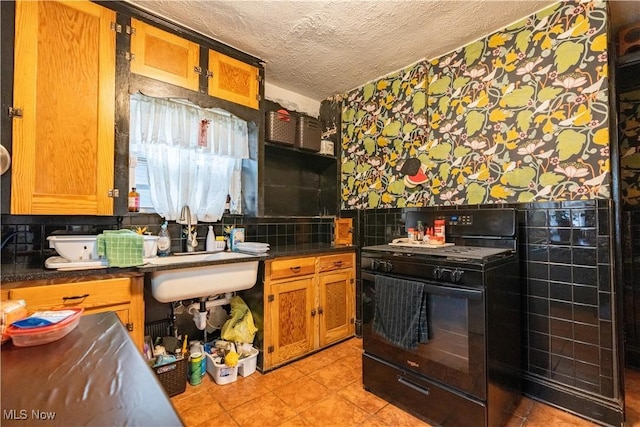 kitchen featuring backsplash, a textured ceiling, gas stove, and light tile patterned flooring