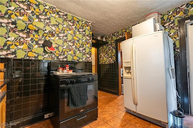 kitchen with white fridge with ice dispenser, black gas stove, light tile patterned floors, and a textured ceiling