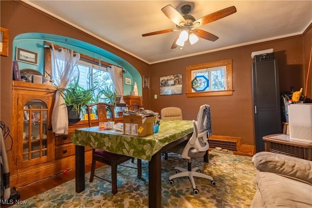 dining space with crown molding, wood-type flooring, and ceiling fan