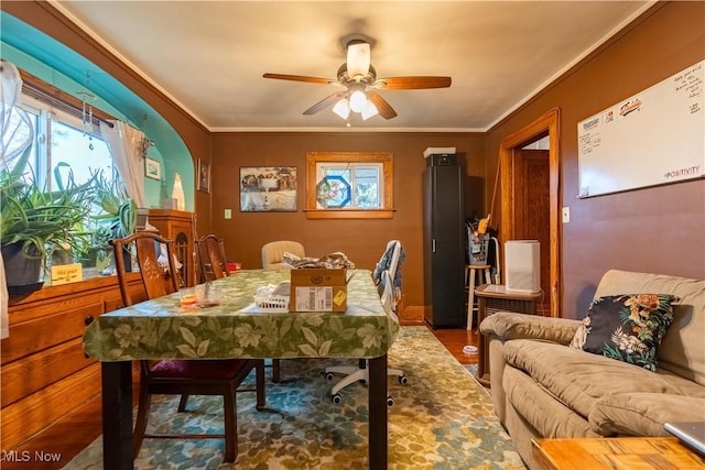 dining room with crown molding, hardwood / wood-style floors, and ceiling fan