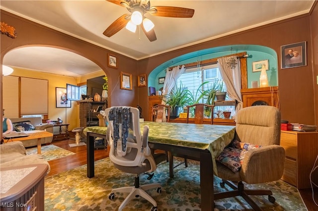 dining space featuring ceiling fan, crown molding, and hardwood / wood-style floors