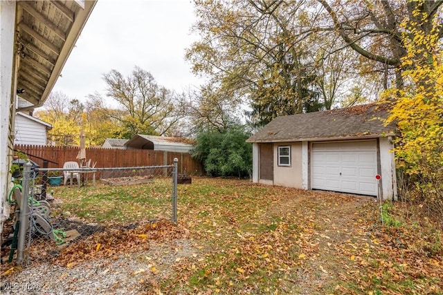 view of yard featuring a garage and an outdoor structure