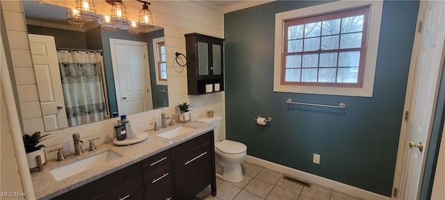 bathroom featuring ornamental molding, visible vents, and a sink