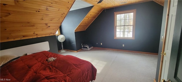 carpeted bedroom featuring lofted ceiling, wood ceiling, and baseboards