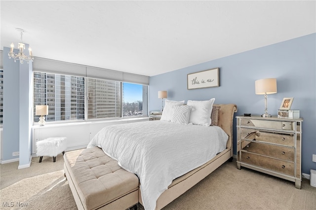 carpeted bedroom featuring a chandelier