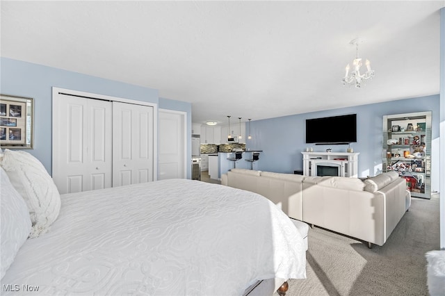 carpeted bedroom with a closet and a notable chandelier