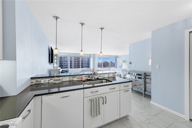 kitchen with sink, white cabinetry, dishwasher, and pendant lighting