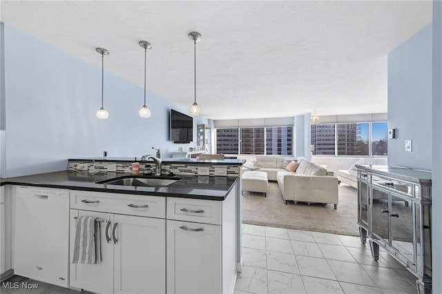 kitchen with white cabinets, dishwasher, hanging light fixtures, and sink