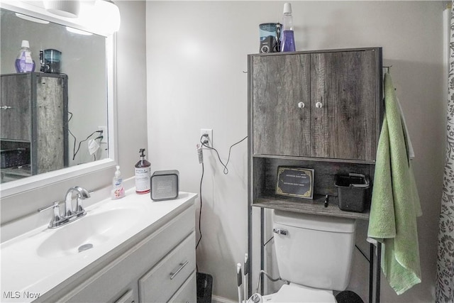 bathroom featuring toilet and vanity